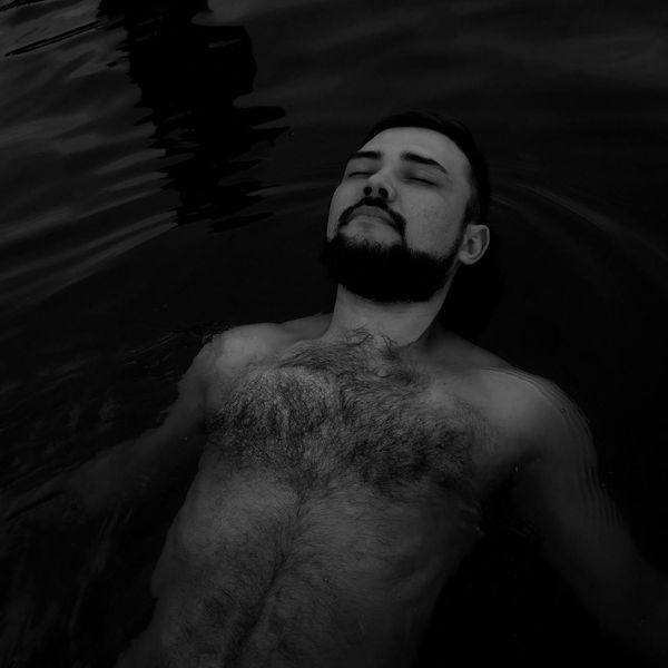 Woman meditating peacefully in a green natural environment.